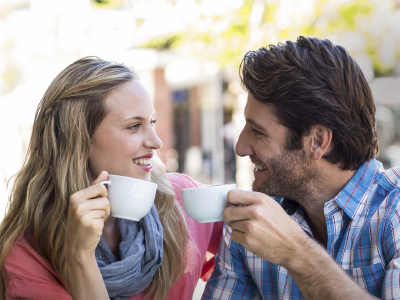 Couple enjoying their coffee outside